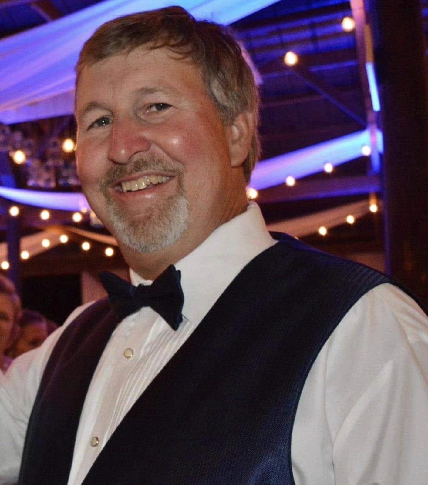 Randy Davis smiling in a bow tie and vest
